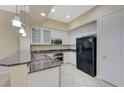 Well-lit kitchen showcasing stainless steel appliances, granite counters, and white cabinets at 50 E Serene Ave # 420, Las Vegas, NV 89123