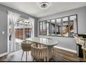 Cozy dining area with a white table, stylish chairs, and sliding glass door, bringing in natural light at 5024 Starfinder Ave, Las Vegas, NV 89108