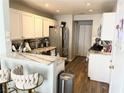 Bright kitchen featuring granite countertops, stainless steel appliances, and a breakfast bar with seating at 5024 Starfinder Ave, Las Vegas, NV 89108