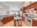 A full kitchen view showing custom cabinets, stainless steel appliances and granite counter tops at 5701 Mary Lou St, Pahrump, NV 89061
