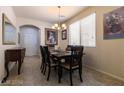 Open dining room with natural lighting, chandelier, and neutral decor, perfect for Gathering meals at 6412 Dimatteo St, Las Vegas, NV 89148