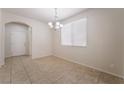 Bright dining room showcasing neutral walls, tile floors, and natural light from the window at 6412 Dimatteo St, Las Vegas, NV 89148