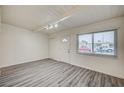 Bright living room featuring wood-look floors, a front door, and a closet at 701 Harvard St, Las Vegas, NV 89107