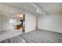 Living room area featuring wood-look floors, which flows into the kitchen at 701 Harvard St, Las Vegas, NV 89107