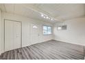 Bright living room featuring wood-look floors, a front door, and a closet at 701 Harvard St, Las Vegas, NV 89107