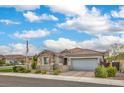 Inviting single-story home with a brick driveway, gated courtyard, and flag pole in a friendly neighborhood at 8257 Skye Peak St, Las Vegas, NV 89166