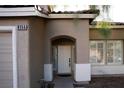 Inviting front entrance showcasing an arched entryway, shutters, and decorative exterior details at 8355 Cabin Peak St, Las Vegas, NV 89123