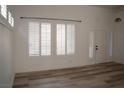 Bright living room featuring new wood floors, white walls, and updated window shutters at 8355 Cabin Peak St, Las Vegas, NV 89123