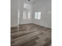 Bright living space with wood floors, white walls, and plantation shutters at 8355 Cabin Peak St, Las Vegas, NV 89123