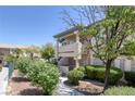 Charming condo exterior featuring well-manicured landscaping, a private balcony, and a welcoming entrance at 8410 Eldora Ave # 1045, Las Vegas, NV 89117