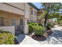 Inviting condo with a gated front patio area with mature plants and trees at 8410 Eldora Ave # 1045, Las Vegas, NV 89117