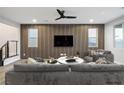Modern living room featuring a sleek accent wall, stylish furnishings and a ceiling fan at 8647 Tortoise Canyon Ct, Las Vegas, NV 89148