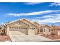 Inviting single-story home featuring a three-car garage, desert landscaping, and neutral stucco exterior at 8664 Frasure Falls Ave, Las Vegas, NV 89178