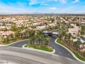 Community featuring tree lined streets and well maintained landscaping with city views in the distance at 8911 Lansberry Ct, Las Vegas, NV 89147