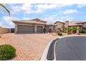 Charming home featuring a landscaped front yard, a paver driveway and a three-car garage at 8911 Lansberry Ct, Las Vegas, NV 89147