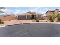 Charming home featuring a landscaped front yard, a paver driveway and a three-car garage at 8911 Lansberry Ct, Las Vegas, NV 89147