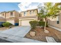 Two-story home has a front-facing two-car garage and a meticulously landscaped front yard at 9019 Winchester Ridge St, Las Vegas, NV 89139