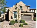 Charming two-story stucco home with brown garage door, landscaped yard and brick paver driveway at , Las Vegas, NV 89138