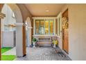 Cozy front porch with brick flooring, decorative pillars, and a comfortable bench at , Las Vegas, NV 89138