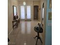 Bright foyer featuring light wood floors and a view of the entrance with glass paneled doors at 1100 Cypress Ridge Ln, Las Vegas, NV 89144