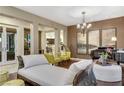 Elegant living room featuring hardwood floors, neutral walls, and stylish decor with direct kitchen view at 12056 Royal Dolnoch Ct, Las Vegas, NV 89141