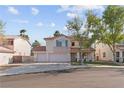 Charming two-story home with a three car garage, tile roof, and desert landscaping at 1287 Dove Tree Ct, Henderson, NV 89014