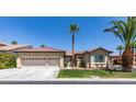 Charming single-story home with a three-car garage and lush landscaping at 1454 Erskine Ave, Las Vegas, NV 89123