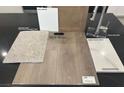 Sample of interior design materials featuring carpet, vinyl plank flooring, and quartz countertops at 148 Silver Run Lane, Las Vegas, NV 89138