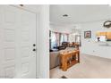 View of the entryway reveals a glimpse into a well-lit living space with warm, inviting decor at 1751 E Reno Ave # 206, Las Vegas, NV 89119