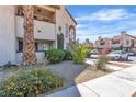 Image shows a clean condo exterior with an unobstructed view of the parking area and beautiful desert landscaping at 1751 E Reno Ave # 206, Las Vegas, NV 89119