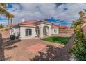Spacious backyard featuring minimal desert landscaping and rock features with a small patch of green grass at 2588 Mizzoni Cir, Henderson, NV 89052