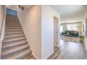 Inviting hallway with stylish hardwood floors and staircase leading to the upper level of the home at 2641 Begonia Falls Ave # 88, North Las Vegas, NV 89081