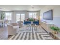 Bright living room featuring contemporary decor, a large window, and sliding glass doors to the backyard at 2641 Begonia Falls Ave # 88, North Las Vegas, NV 89081