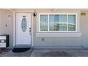 Close-up of the front door with a decorative window and a view reflecting in the window next to it at 2712 Holmes St, North Las Vegas, NV 89030