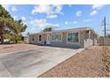 An inviting single-story home with a long driveway and low-maintenance desert landscaping at 2712 Holmes St, North Las Vegas, NV 89030