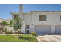 Two-story home featuring an attached two-car garage and manicured lawn at 2902 Aztec Lily Ln, Henderson, NV 89074