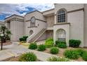 Charming condo building featuring lush landscaping and easy access stairs, enhancing the overall appeal at 3150 Soft Breezes Dr # 2046, Las Vegas, NV 89128