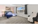 Bright bedroom featuring a plush bed, large window overlooking the neighborhood, and a comfortable chair at 3208 Alcoa Ave, Las Vegas, NV 89102