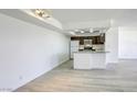 Open-concept with wood-look floors, and a kitchen featuring granite countertops and stainless steel appliances at 3930 University Center Dr # 311, Las Vegas, NV 89119