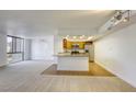Bright living room and kitchen combo with carpet, hardwood floors, a breakfast bar, and natural light at 3930 University Center Dr # 312, Las Vegas, NV 89119
