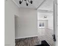 Bright, modern entry featuring wood floors, neutral paint, and a view into the open living space at 4417 Saint Andrews Cir, Las Vegas, NV 89107