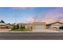 Inviting single-story home with desert landscaping, a two-car garage, and a peaceful sunset backdrop at 4998 Rappahanock St, Las Vegas, NV 89122