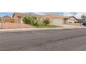 Charming single-story home with desert landscaping, a two-car garage, and a well-manicured lawn at 4998 Rappahanock St, Las Vegas, NV 89122