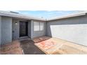 View of the front door with gray stucco and low maintenance landscaping at 508 Van Dornum Ave, Henderson, NV 89011