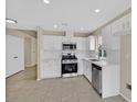 Updated kitchen featuring stainless steel appliances, white cabinets and tile flooring at 5820 Royal Castle Ln, Las Vegas, NV 89130