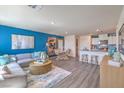 Open living space with stylish decor, connecting the living room, dining area, and kitchen at 6109 Aster Garden St # 159, North Las Vegas, NV 89081