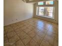 Bright bedroom featuring neutral walls, tile floors, and large windows at 6529 Bradford Ln, Las Vegas, NV 89108