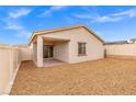 Spacious backyard with gravel landscaping, patio, and a covered area for outdoor living at 6725 Lotus Vista Ct, Las Vegas, NV 89156