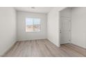 Bright bedroom featuring wood-look floors, a window, and neutral paint at 6725 Lotus Vista Ct, Las Vegas, NV 89156