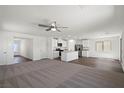 The open-concept living space seamlessly integrates carpeted and wood-look vinyl flooring at 6772 Violet Cascade Ave, Las Vegas, NV 89156